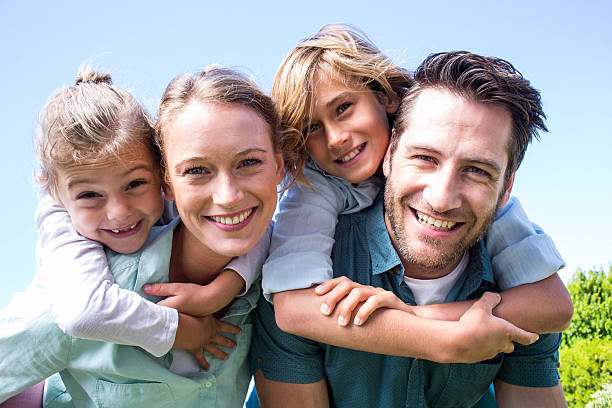 Happy parents with their children in the countryside